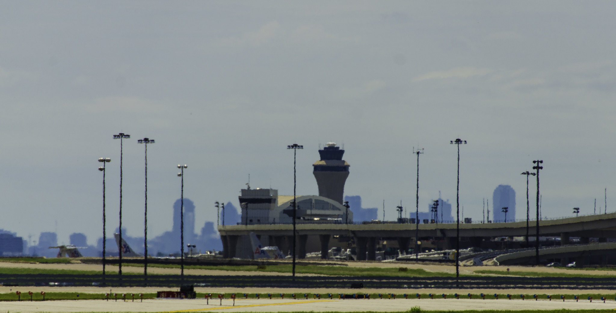 DFW airport tower and runways with the city skyline in the background