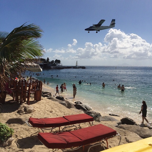 View of Maho Beach and the arriving planes from the Driftwood Boat Bar via Seth Miller/PaxEx.aero